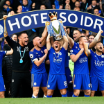 **Leicester City Victory Celebration:** Image of jubilant Leicester City players celebrating their Premier League victory. Focus on the team spirit and authenticity that defied the odds. Include a nod to their social media engagement, perhaps with fans celebrating alongside. The mood is energetic and triumphant, capturing the "magic of the Foxes."